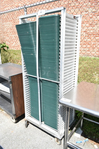 Metal Pan Transport Rack on Commercial Casters w/ Approximately 220 Green Poly Trays. 