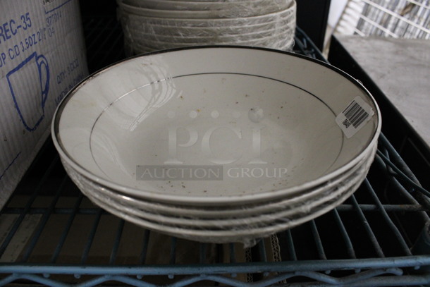 22 White Ceramic Bowls w/ Silver Colored Lines on Rim. 9x9x2.5. 22 Times Your Bid!
