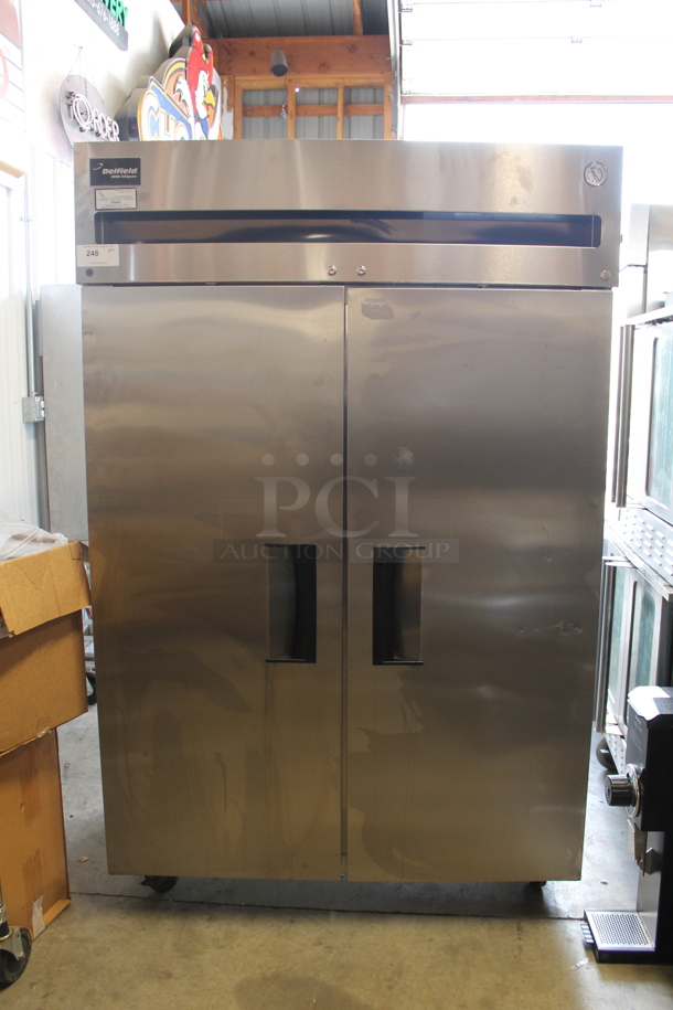 Delfield 6000 XL Stainless Steel Commercial 2 Door Reach In Cooler w/ Poly Coated Racks on Commercial Casters. Tested and Powers On But Does Not Get Cold