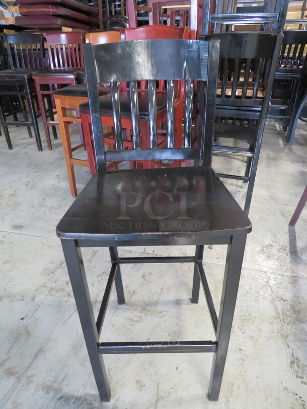 One Metal Bar Height Chair With A Black Wooden Seat. 