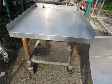 One Stainless Steel Equipment Table With Under Shelf On Casters. 25X30X25