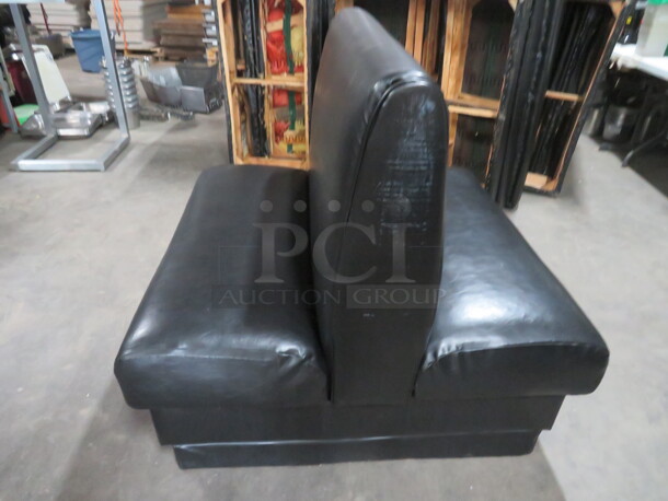 One Double Sided Booth With Black Cushioned Seat And Back. 48X48X43