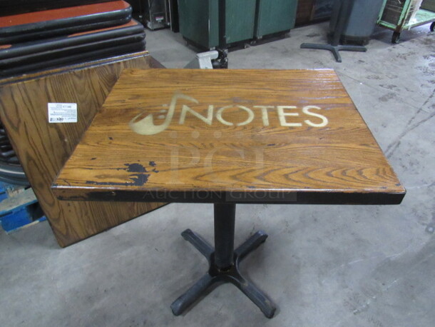 One 2 Inch Thick Solid Wood Table Top With The NOTES Logo  On A Pedestal Base. 30X24X30