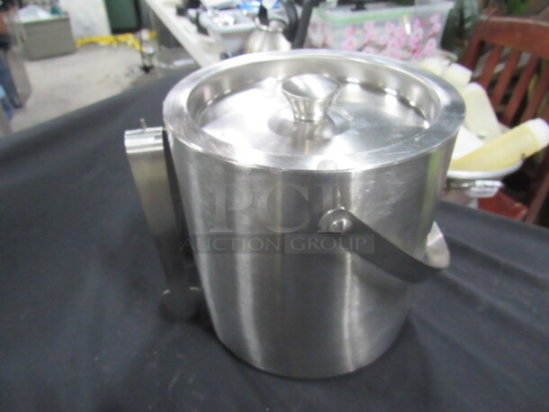 One Stainless Steel Ice Bucket With Lid And Tongs.