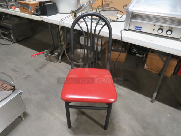 Black Metal Chair With A Red Cushioned Seat. 4XBID
