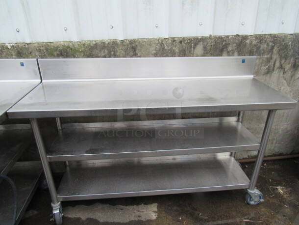 One Stainless Steel Table With 2 Stainless Under Shelves, On Casters. 60X20X40