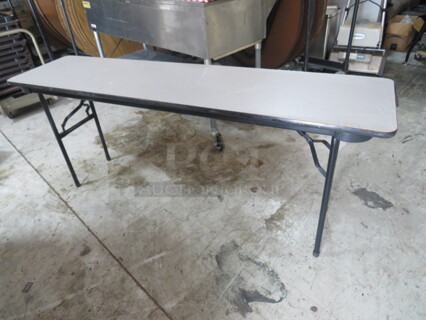 One Norwood Folding Table With Laminate Top And Metal Legs. 72X18X29