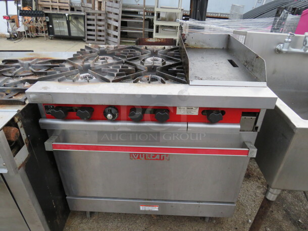 One Vulcan Natural Gas 4 Burner/12 Inch Griddle Range With 1 Rack. Working When Removed. Model# 36SL. 36X30X38. $10,130.00. - Image 1 of 2