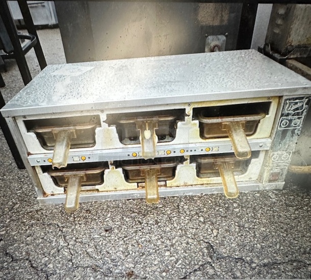 One Duke Dual Sided 6 Hole Warmer. Model# FWM3-23. 120 Volt. Not Working. 28.5X16X12.  - Image 1 of 1