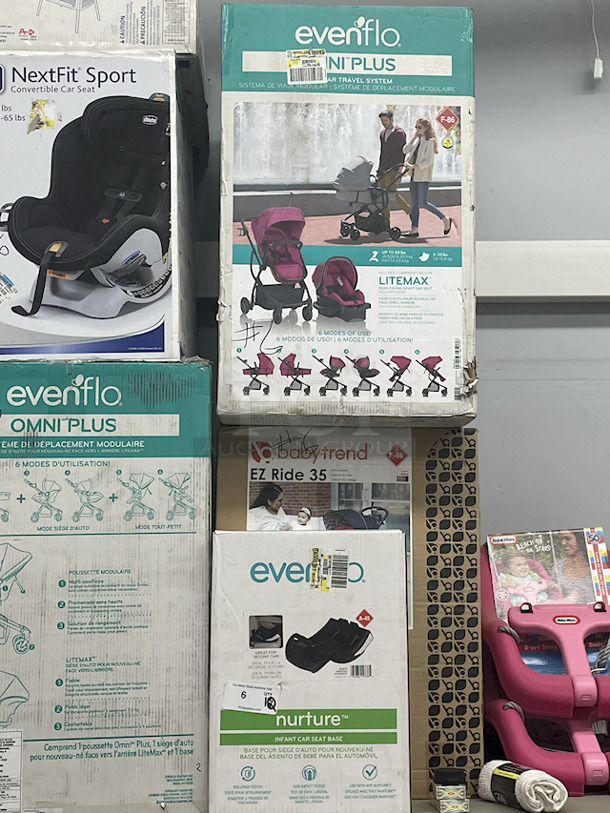 MASSIVE LOT! (3) Little Tikes 2-In-1 Snug & Secure Swings – 1 Blue, 2 Pink; (17) Nuby Water Resistant Baby Bibs (assorted colors); (1) Graco “Caden Fashion” Comfy Cruiser™ Travel System With Snugride® 30; (1) Allen YOOGO CZ2 Convertible Cargo Trailer → Handy Pull Cart,  (1) Delta Children Sweet Slumber Bassinet, (1) Chicco LullaGo Portable Bassinet, (1) Chicco NextFit Sport Convertible Car Seat, (2) Evenflo Omni Plus Modular Travel System – Includes LITEMAX Rear-Facing Infant Car Seat, (1) Baby Trend EZ Ride Girl 35 - Includes NEW 4-35 Ibs Infant Car Seat , (1) Evenflo Nurture Infant Car Seat Base. 11x Your Bid - Image 6 of 12