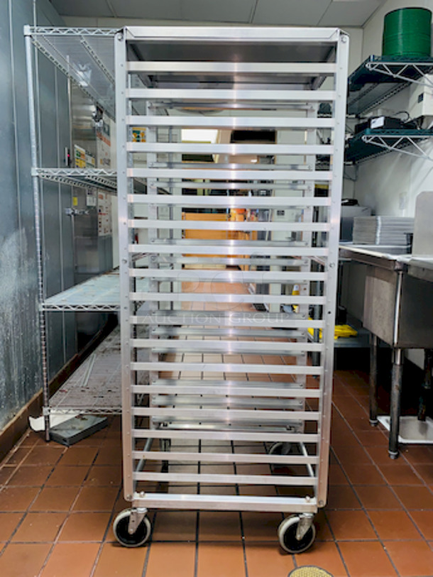 ALMOST PERFECT! Lockwood RA64-ER18ES Intermediate Height 18 Level 64" End Load Rack.
Condition: 8/10 
A hard working, versatile line of racks
Construction: High tensile extruded aluminum
Dimensions: 64"H x 21 3/8"W x 26 1/2"D
Tray supports: 1-1/2″ wide extruded pan supports riveted to uprights
Center Spacing: 3"
Pan Capacity: (18) 18" x 26" pans
Casters: 5" non-marking swivel threaded stem
Actual Weight: 45 lbs. - Image 4 of 6
