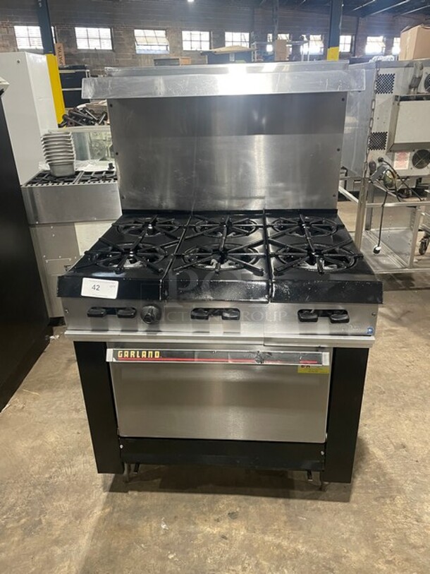 Great! Garland Commercial Natural Gas Powered 6 Burner Stove! With Oven Underneath! All Stainless Steel! With Raised Back Splash! GREAT FOR BIG POTS! On Legs! - Image 1 of 8