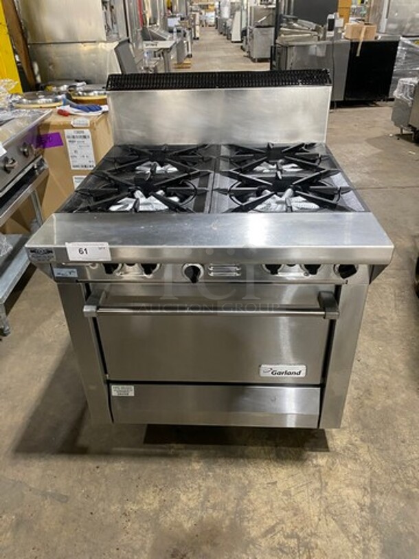 Garland Commercial Natural Gas Powered 4 Burner Stove! With Back Splash! With Oven Underneath! Metal Oven Rack! All Stainless Steel! On Casters! Model: 144R SN: 1601100100589 - Image 1 of 10