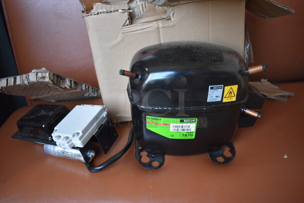 BRAND NEW IN BOX! Secop Model SC18MNX Metal Commercial Compressor. 115 Volts, 1 Phase. 9x6x8