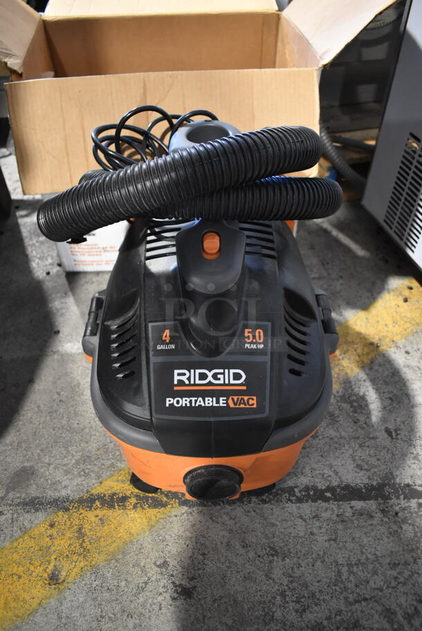IN ORIGINAL BOX! Rigid WD4070 Orange and Black Poly 4 Gallon Portable Wet Dry Vac Vacuum Cleaner. 120 Volts, 1 Phase. Tested and Working! - Image 1 of 5