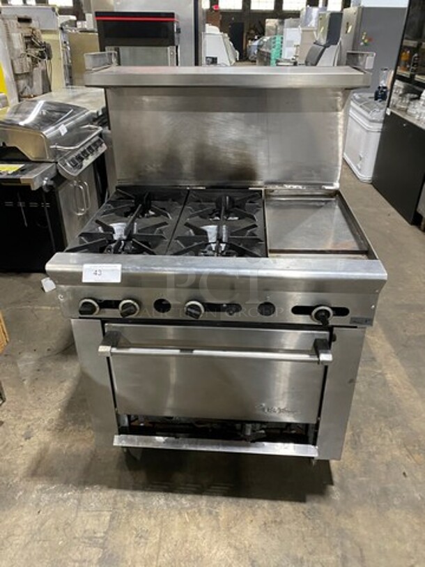 US Range Commercial Natural Gas Powered 4 Burner Stove With Built In Flat Grill! Flat Grill Has Side Splashes! With Raised Back Splash And Salamander Shelf! With Oven Underneath! All Stainless Steel! On Legs!