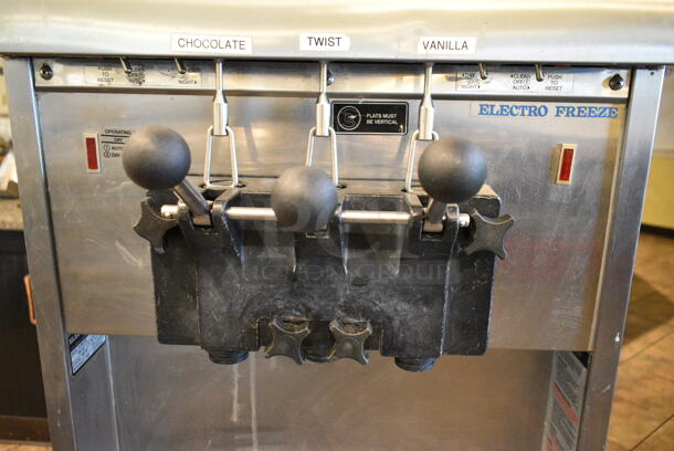 Electro Freeze SL500-132 Stainless Steel Commercial Floor Style Water Cooled 2 Flavor w/ Twist Soft Serve Ice Cream Machine on Commercial Casters. 208-230 Volts, 3 Phase. This Unit Was In Working Condition When the Restaurant Closed. (main dining room) - Image 6 of 10