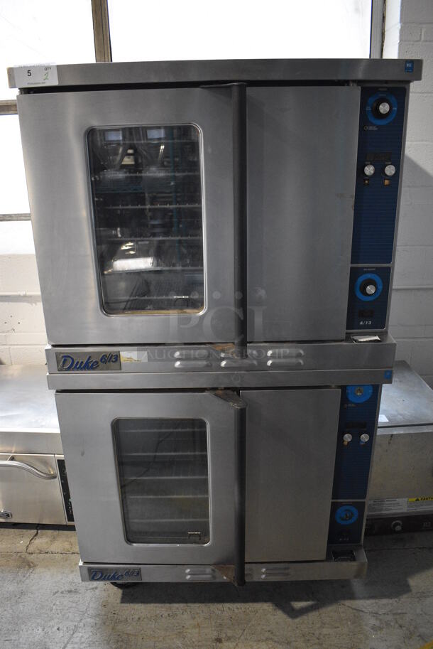 2 Duke Stainless Steel Commercial Natural Gas Powered Full Size Convection Ovens w/ View Through Door, Solid Door, Metal Oven Racks and Thermostatic Controls on Commercial Casters. 38x38x69. 2 Times Your Bid!