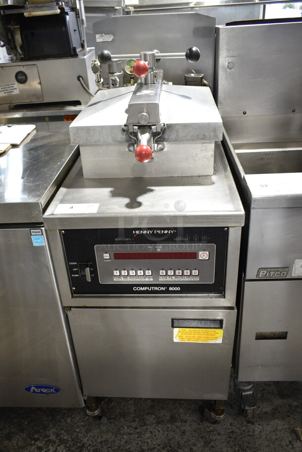 Henny Penny 600C Stainless Steel Commercial Floor Style Natural Gas Powered Pressure Fryer on Commercial Casters. 80,000 BTU.  - Image 1 of 9