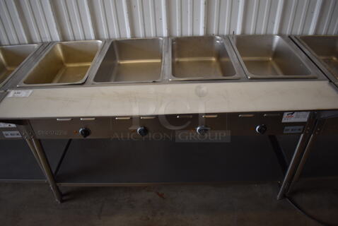 ServIt 423EST4WE750 Stainless Steel Commercial Electric Powered 4 Bay Electric Powered Steam Table w/ Cutting Board and Under Shelf. 208/240 Volts. 58x30x34