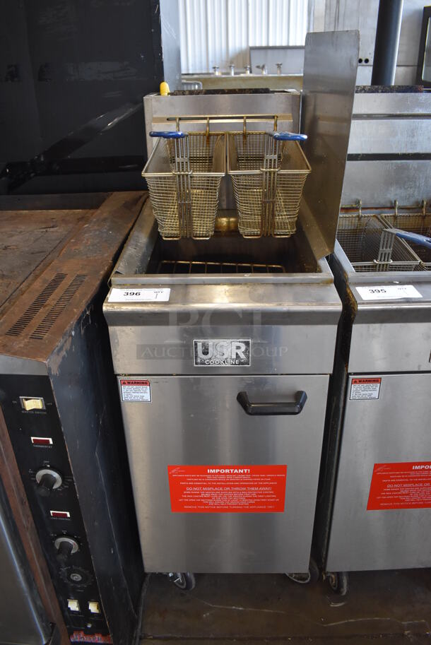	2019 USR Cookline CF-40 Stainless Steel Commercial Floor Style Natural Gas Powered Deep Fat Fryer w/ 2 Metal Fry Baskets, Right Side Splash Guard and Adapter on Commercial Casters. 90,000 BTU. 16x30x51