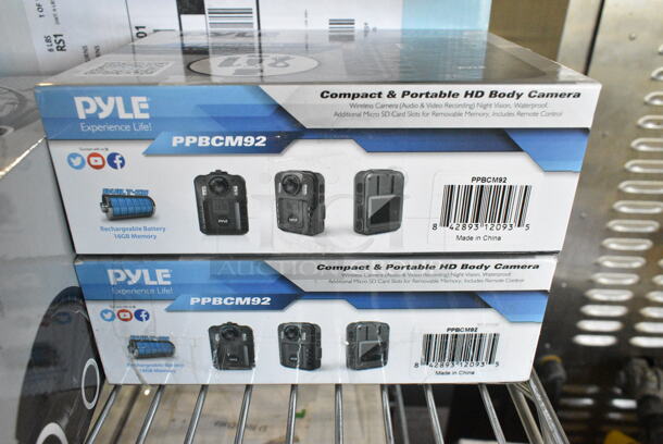 12 IN ORIGINAL BOX! Items Including 2 Pyle PPBCM92 HD Body Camera, Knox Gear TX 100 Closed Back Studio Monitor Headphones, Pyle PLBLSP40 Back Up Camera, SereneLife Electric Air Pump Compressor Air Inflator, Pyle PLIO90BL High Power Subwoofer,  Pyle Desktop USB Podcast Microphone Kit PDMIKT140, 2 Pyle PL63BL Speakers Blue, Pyle PMXU83BT 8-Channel Bluetooth Studio Mixer, SereneLife SLSBIN21 Security Locking Storage Container Bin, Honeywell 4 Liter Mini Fridge, Windowfan. 12 Times Your Bid!  - Image 2 of 12