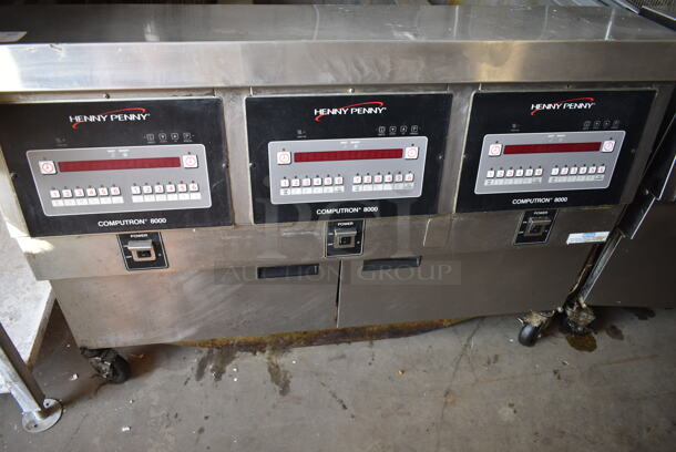 2016 Henny Penny OGA-323 ENERGY STAR Stainless Steel Commercial Natural Gas Powered 3 Bay Fryer w/ 4 Metal Fry Baskets on Commercial Casters. 255,000 BTU.  - Image 3 of 12