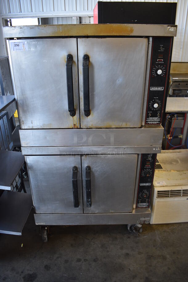 2 Hobart Stainless Steel Commercial Natural Gas Powered Full Size Convection Oven w/ Solid Doors, Metal Oven Racks and Thermostatic Controls on Commercial Casters. 40x33x69.5. 2 Times Your Bid!