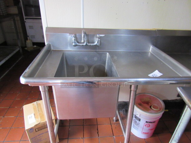One Stainless Steel Sink With Right Side Drain Board And Faucet. 40X27X41. BUYER MUST REMOVE!