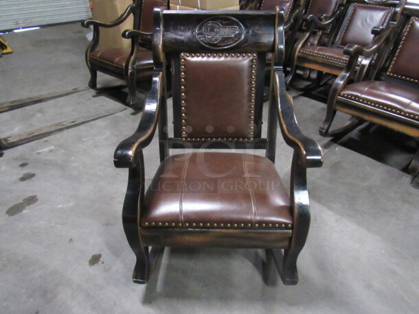 One Limited Edition Solid Wood GEORGE JONES Rocking Chair With The GJ Logo Engraved On The Top And Leather Cushioned Seat And Back With Nail Head Trim And Numbered Plate On The Back. DONT MISS THIS!!!!!