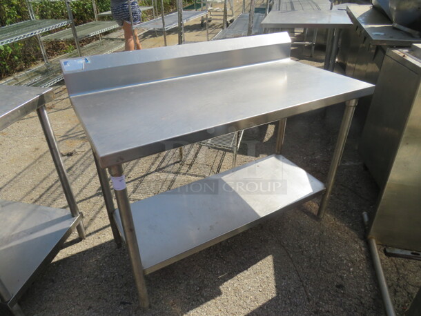 One Stainless Steel Table With Stainless Under Shelf, And Back Splash. 48X24X40 - Image 1 of 1