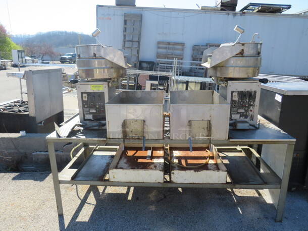 One Gold Medal Cretors Dual Popcorn Machine On A Stainless Steel Work Table With 3 Scoops. Model# G32FP. 120/208 Volts. 75X30X62.  