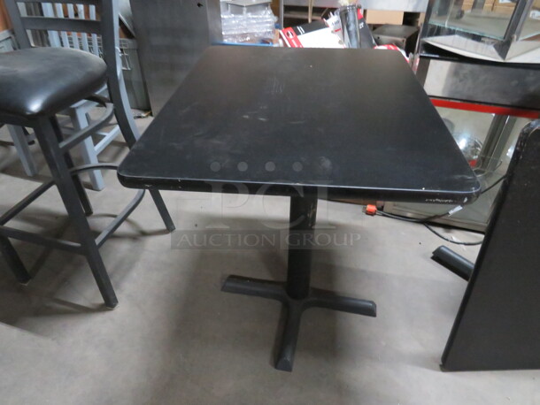 One Black Laminate Table Top On A Pedestal Base. 24X30X29