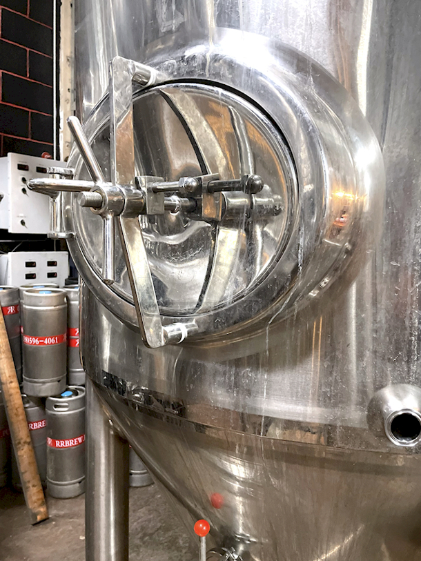 ? ?  BEAUTIFUL!! Stout Tanks & Kettles - 15 BBL Fermenter / Unitank (Jacketed). ? ?                 Features: Easily Converts to a Unitank or Brite Serving Tank;
Glycol Jacketed - 2 Zones: Cone and Sidewall; 
Shadowless Manway for Easy Cleaning;
Adjustable Racking Arm for Clear Transfer;
1.5" Sample Valve for Quality Testing;
Back Mounted Pressure Gauge;
Adjustable Feet for Leveling on Uneven Floors or Fine Height Adjustments;
Pressure Gauge Type:  Back Mount;
CIP Arm and 2.5" Rotating CIP Spray Ball;
2 Butterfly Valves;
Rated to 2-Bar (29 PSI);
1/2" NPT Welded Thermowell for Contactless Temperature Probe
Tank Thickness: 3mm
Jacket and Outer Shell Thickness: 2mm.
Cone: 60 degree Interior Angle.
51.5-in. diameter x 125-in.H. - Image 7 of 8