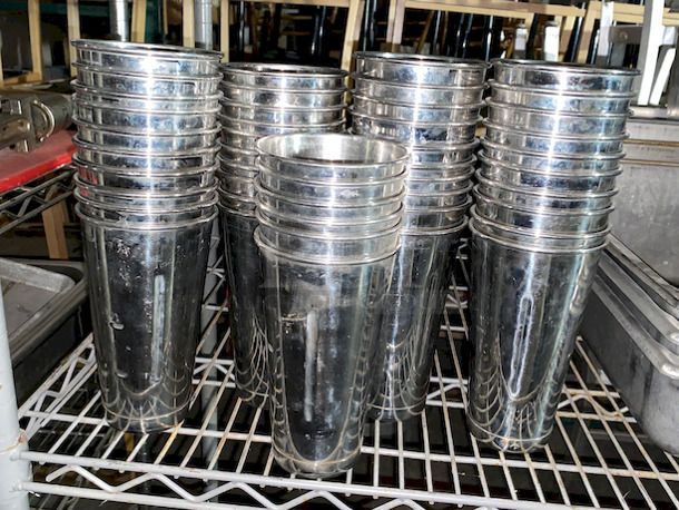 EVERYTHING ON THE SHELVES! Includes 8 Perforated Full Size Pans (2” Deep”), 46 Stainless Steel Milkshake Cups, 3 Full Size Pans (4” Deep), (3) 6” Deep 1/3 Pans, ¼ Pan, 4” Deep Full size Pans, (79)  Aladin Temp-Rite Induction Heated Dishes With (39) Covers and (25) Bowls,  San Jamar SAF-T-ICE Tote.  - Image 10 of 12