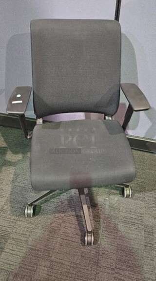 Black Steelcase office desk chair with armrests, black framing and wheels. Adjustable and in good condition! Shows normal signs of use. Measures 41” H x 26.5” W. 
