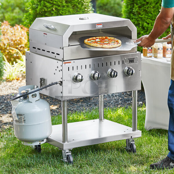 LIKE NEW! 2022 Backyard Pro 554LPG36 Stainless Steel Commercial Propane Gas Powered Outdoor Grill w/ Brick Oven Attachment and Under Shelf on Commercial Casters. Stock Picture Used as Gallery. Tested and Working! - Image 1 of 7