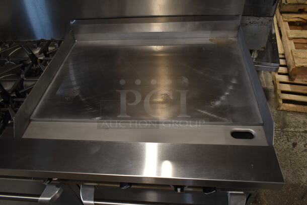 BRAND NEW SCRATCH AND DENT! 2023 Garland G60-4G36RR Stainless Steel Commercial Natural Gas Powered 4 Burner Range w/ Flat Top Griddle, 2 Ovens, Back Splash and Over Shelf. Stock Picture Used as Gallery. - Image 2 of 10