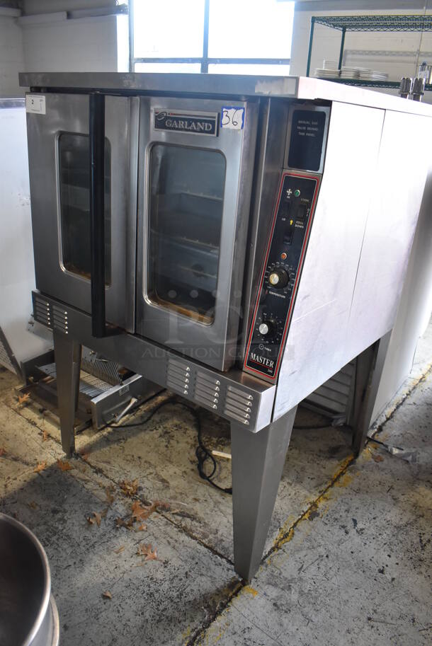 Garland Master 200 Stainless Steel Commercial Natural Gas Powered Full Size Convection Oven w/ View Through Doors, Metal Oven Racks and Thermostatic Controls on Metal Legs. 38x38x58
