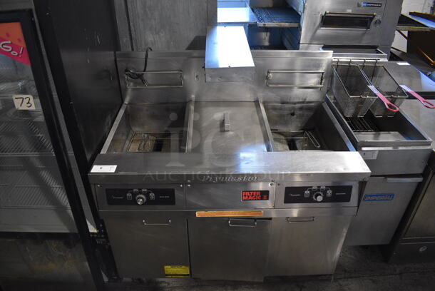 Frymaster FMH250SE Stainless Steel Commercial Natural Gas Powered Double Bay Deep Fat Fryer w/ Center Dumping Station and Filtration System on Commercial Casters. 80,000 BTU. 47x32x51
