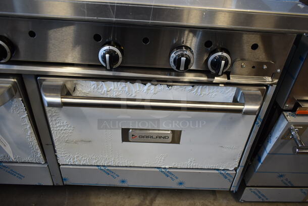 BRAND NEW SCRATCH AND DENT! Garland G60-4G36RR Stainless Steel Commercial Natural Gas Powered 4 Burner Range w/ Flat Top, 2 Ovens, Over Shelf and Back Splash.  - Image 7 of 10