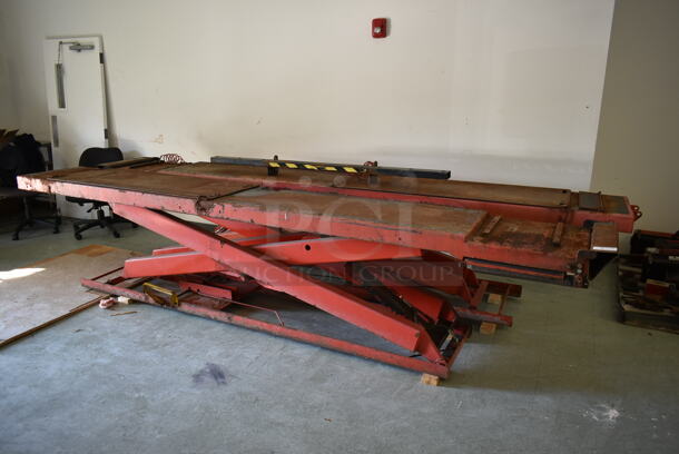 Wheeltronic 005/65-110 Red Metal 4,000 Pound Capacity Car Lift. Was In Working Condition When Class Ended. BUYER MUST REMOVE. (Main Building)