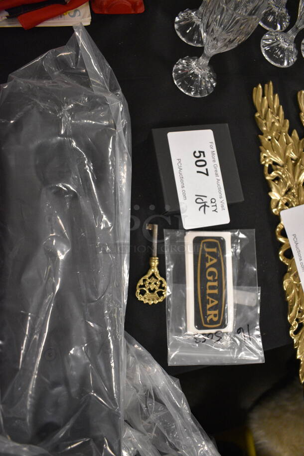ALL ONE MONEY! Jaguar Stickers, Gold Colored Key, Aston Martin License Plate Holder, and Lamborghini Cuff Links with Box - Image 1 of 6