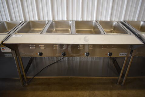 ServIt 423EST4WE750 Stainless Steel Commercial Electric Powered 4 Bay Electric Powered Steam Table w/ Cutting Board and Under Shelf. 208/240 Volts. 58x30x34