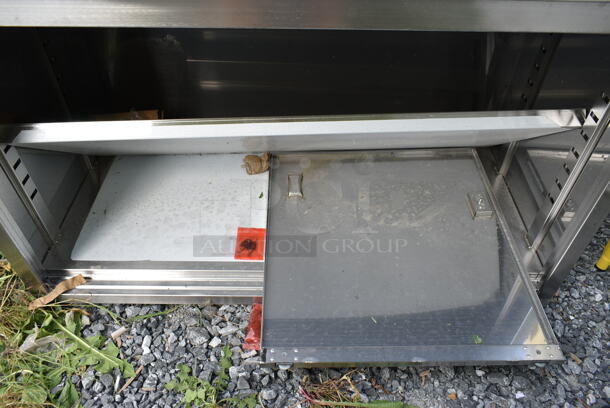 BRAND NEW SCRATCH AND DENT! Regency 600EBT2448D 24" x 48" 16 Gauge Type 304 Stainless Steel Enclosed Base Table with Sliding Doors and Adjustable Midshelf - Image 3 of 4