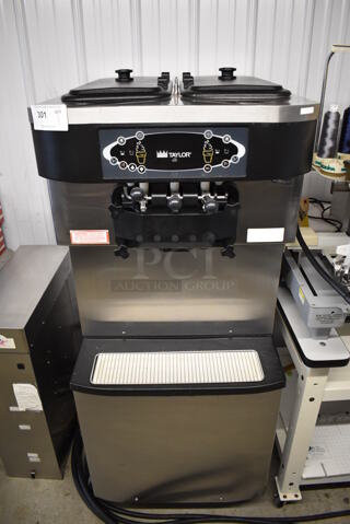 Taylor C713-27 Stainless Steel Commercial Floor Style Water Cooled 2 Flavor w/ Twist Soft Serve Ice Cream Machine on Commercial Casters. 208-230 Volts, 1 Phase. 25x40x60