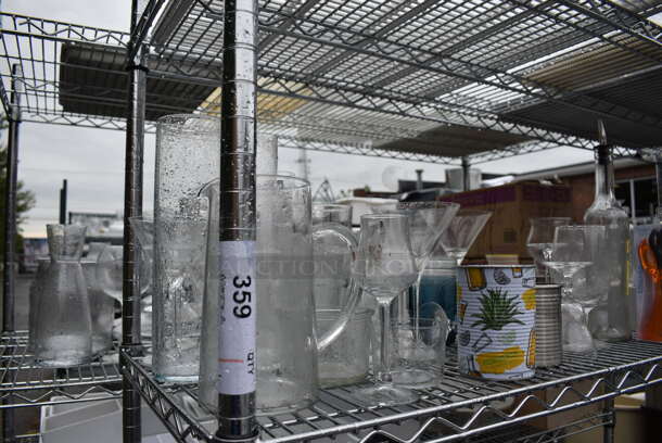ALL ONE MONEY! Lot of Chrome Finish 4 Tier Shelving Unit on Commercial Casters w/ All Contents Including Glassware, Ceramic Plates, Metal Ice Bucket. DISMANTLE FOR SHIPPING. PLEASE CONSIDER FREIGHT CHARGES. 60x18x79 - Image 2 of 8