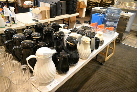 ALL ONE MONEY! Lot of Various Items Including Poly Coffee Carafes and Coffee Pots. Does Not Include Table. (main dining room)