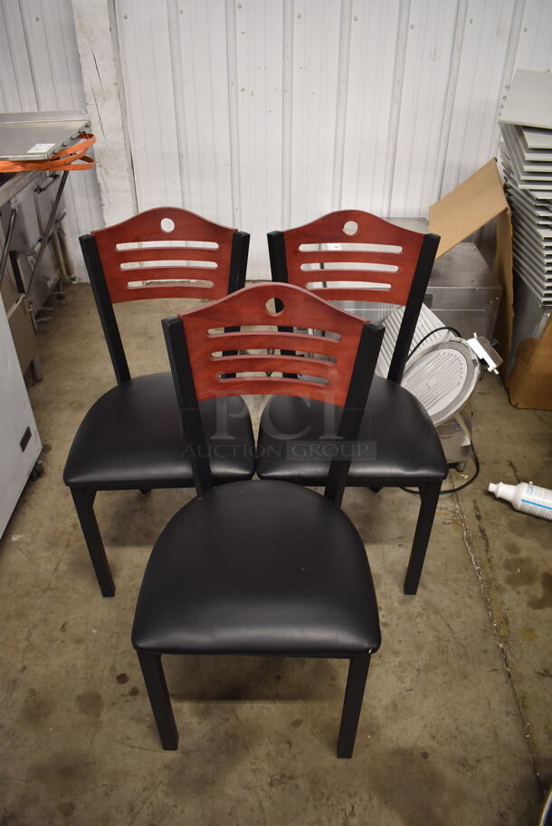 3 Black Cushioned Chairs With Wood Style Ladder Backs on Black Legs. 3 Times Your Bid! Cosmetic Condition May Vary. 