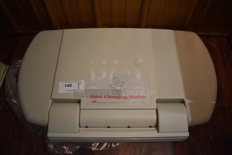 Tan Poly Wall Mount Diaper Changing Station. 34x3.5x21. (bar)